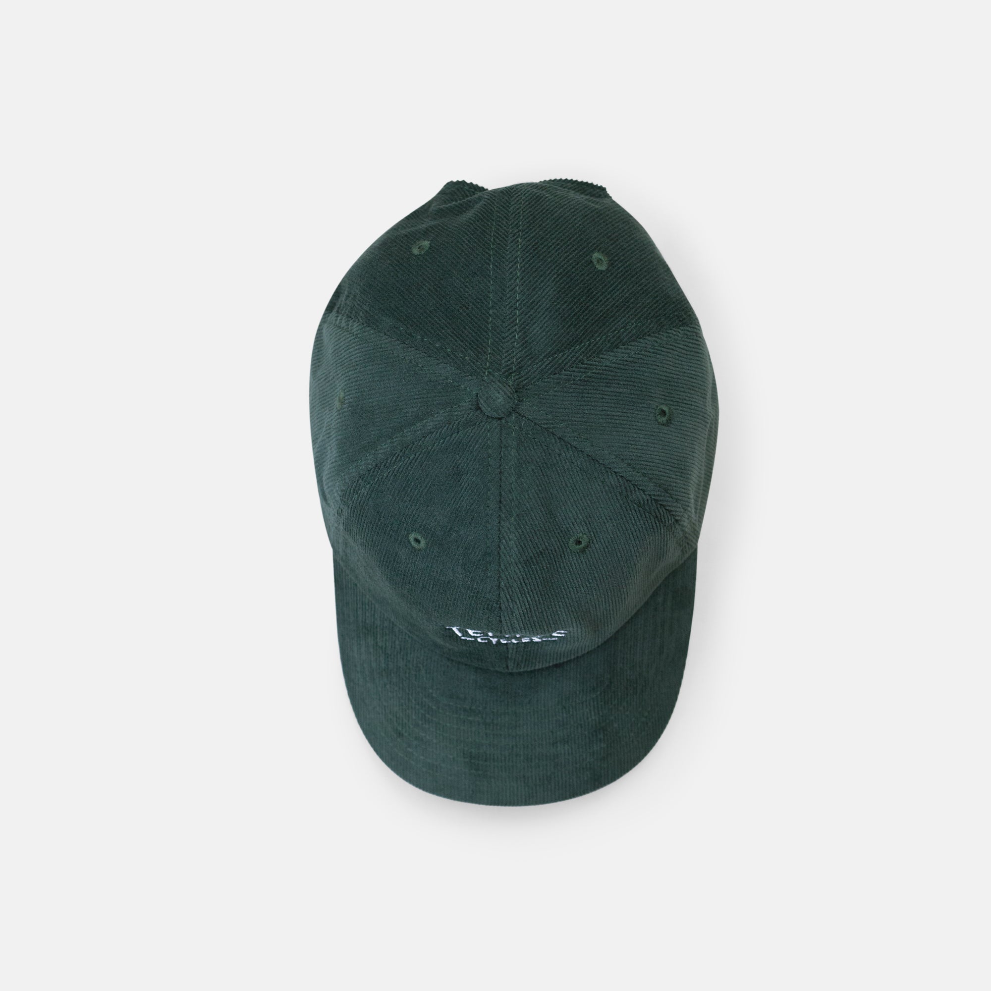 Top view of sustainable, super comfy green corduroy hat, studio setting. 