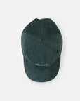 Top view of sustainable, super comfy green corduroy hat, studio setting. 