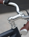 Neco silver headset with polished silver sweep handlebars on a classic vintage e-bike.