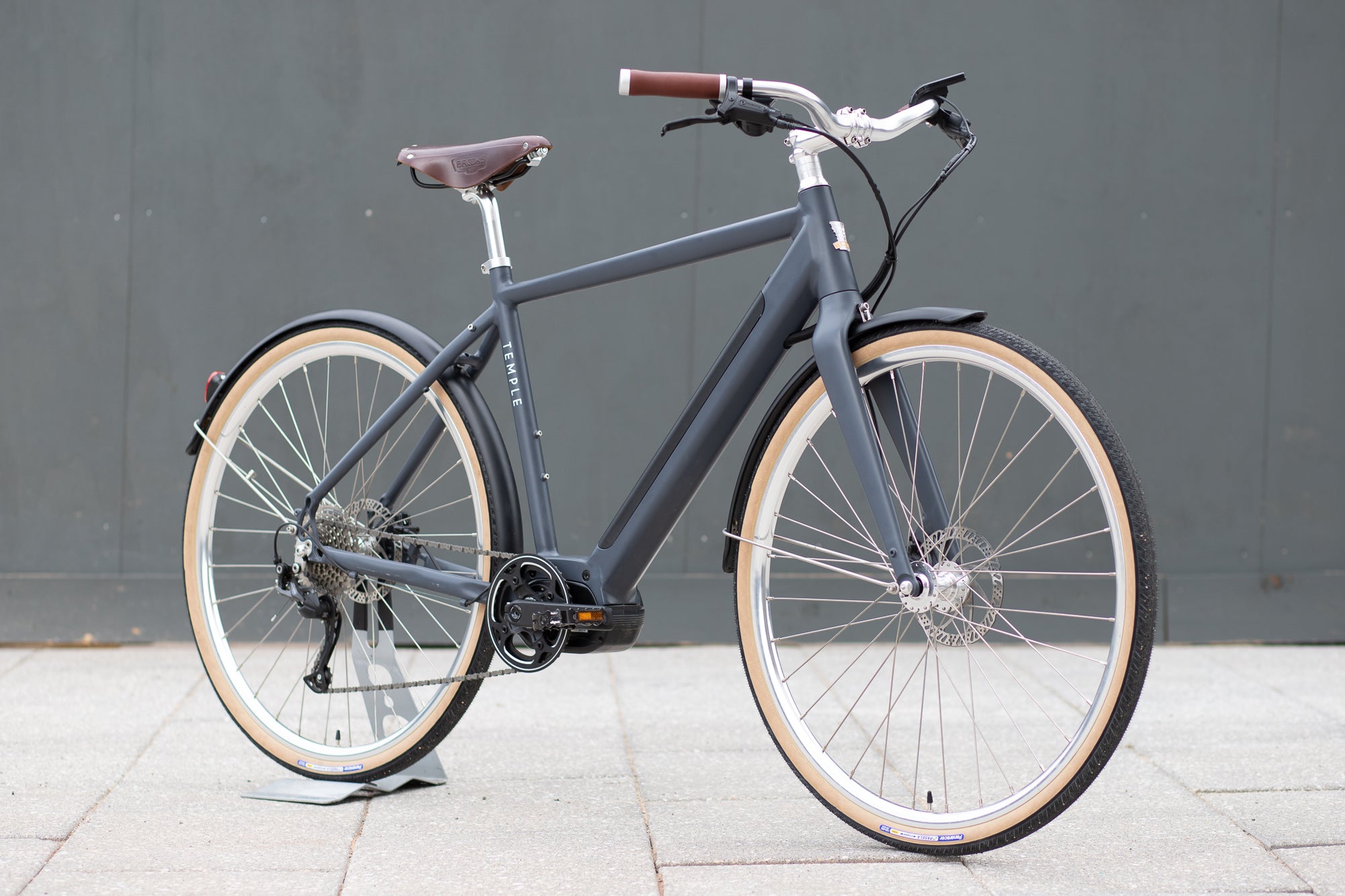 Classic black electric bike, urban setting. 