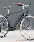 Classic black electric bike, urban setting. 