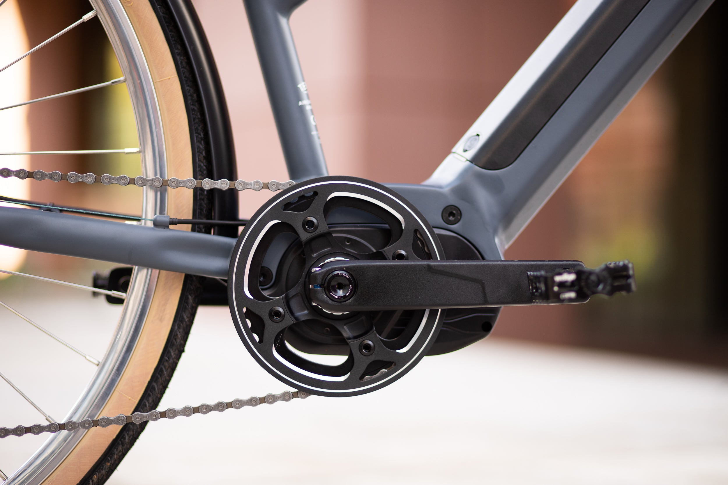 Wellgo hybrid pedals and Shimano Altus gears on a black e-bike.