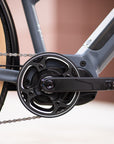 Wellgo hybrid pedals and Shimano Altus gears on a black e-bike.