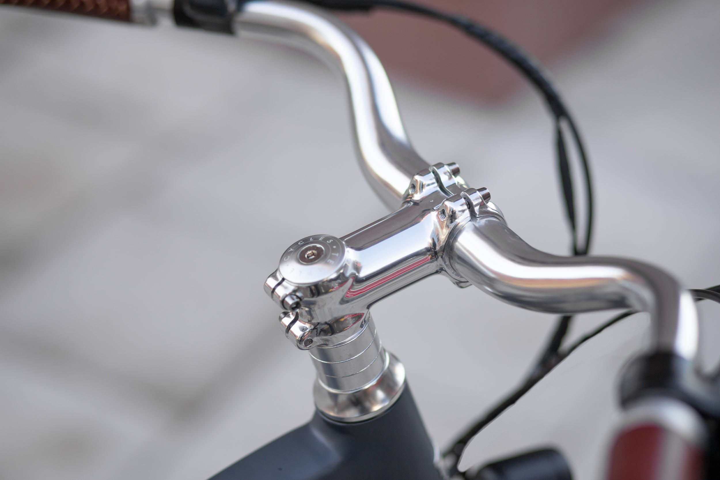 Laser-engraved Temple head set with sweep handlebars on a Step through Electric bike.