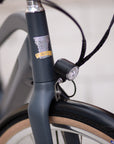 Dark blue headset, Temple head badge and bike light on a Step Through e-bicycle. 