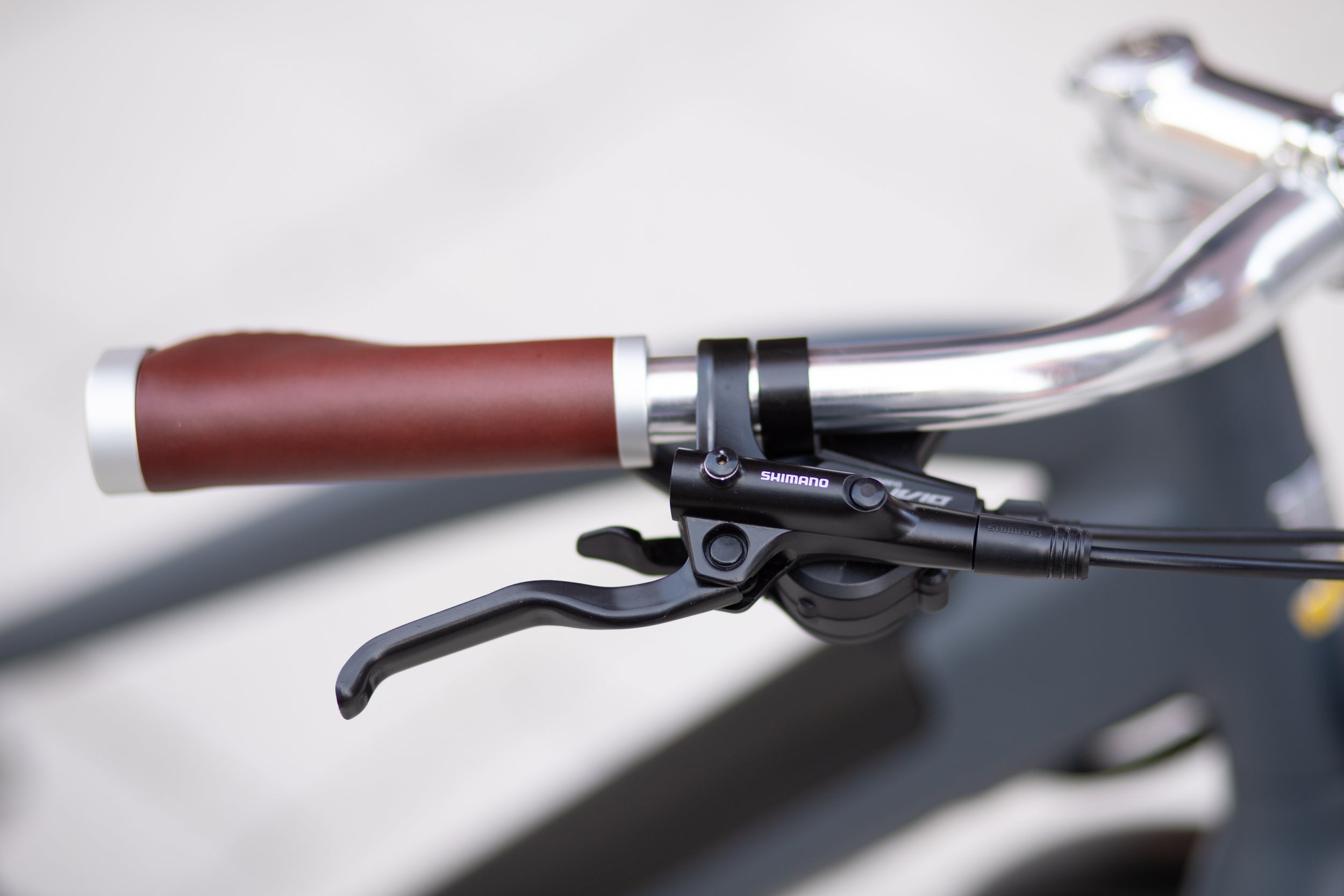 Left Shimano brake lever on a classic adventure e-bicycle.