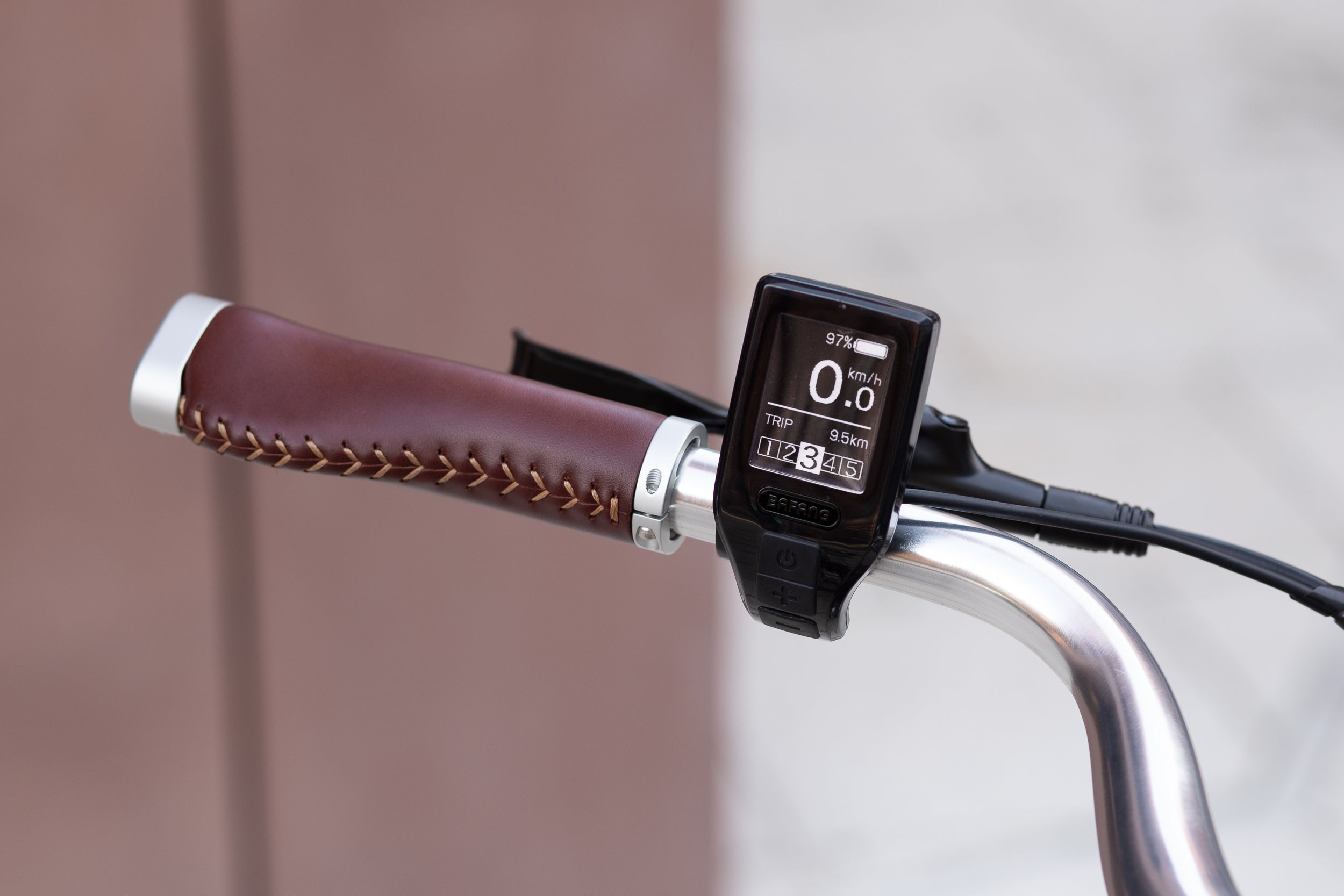 Shimano Altus 9 speed gear shifter on the left handlebar of a classic e-bike.