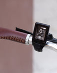 Shimano Altus 9 speed gear shifter on the left handlebar of a classic e-bike.