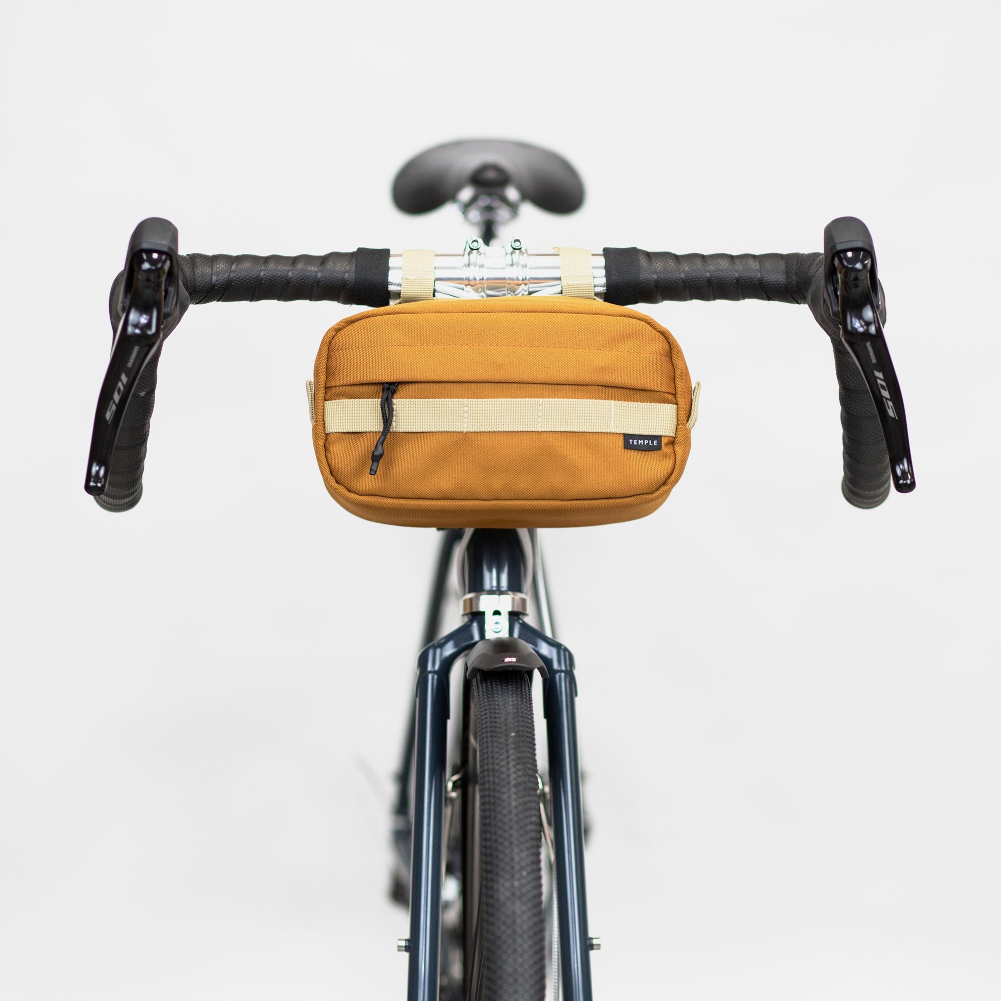 Front view of a premium bicycle bar bag attached to bike handlebars, studio setting.