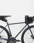 Three dusky black premium cycling bags attached to a Temple bicycle, studio setting.