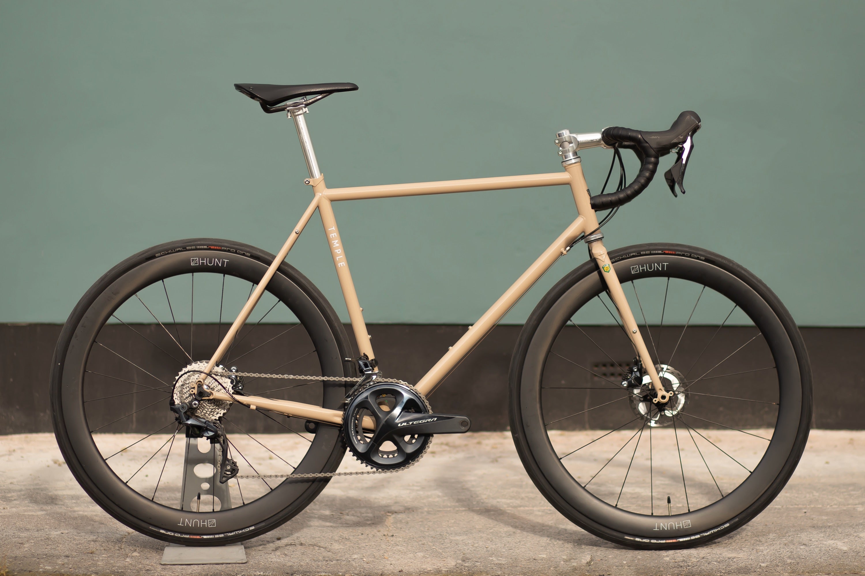 Sand coloured lightweight road bicycle, urban setting. 