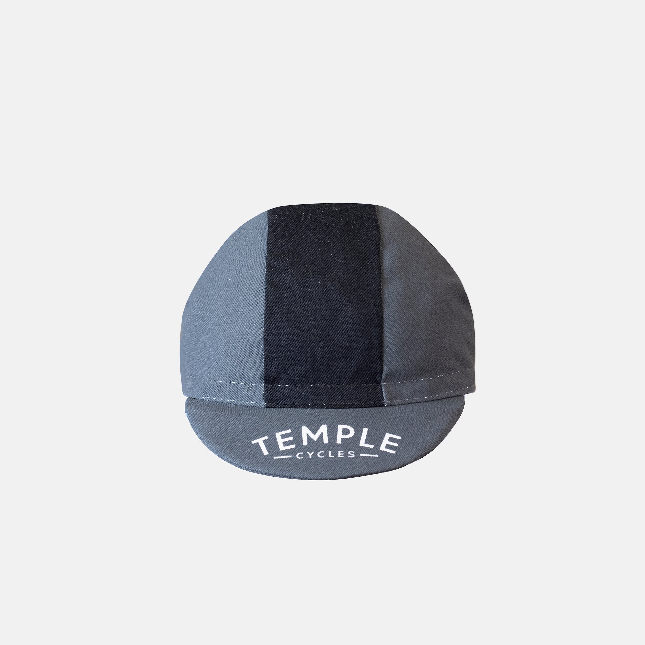 Temple branded peak of men’s cycling cap with black stripe, studio setting. 