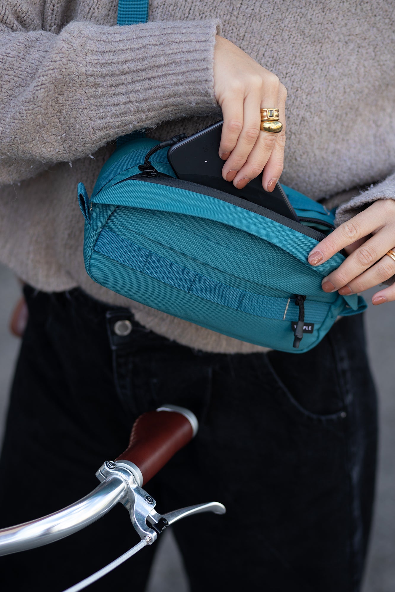 Women modelling a versatile cross body/ bum bag in green.