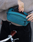 Women modelling a versatile cross body/ bum bag in green.