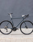 Navy, functional road bike, urban setting.