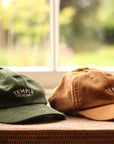 Dark green and brown corduroy caps with embroidered Temple logo, window setting.