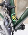 Reynolds 853 steel frame emblem and Shimano chainset on a dark green road bike.
