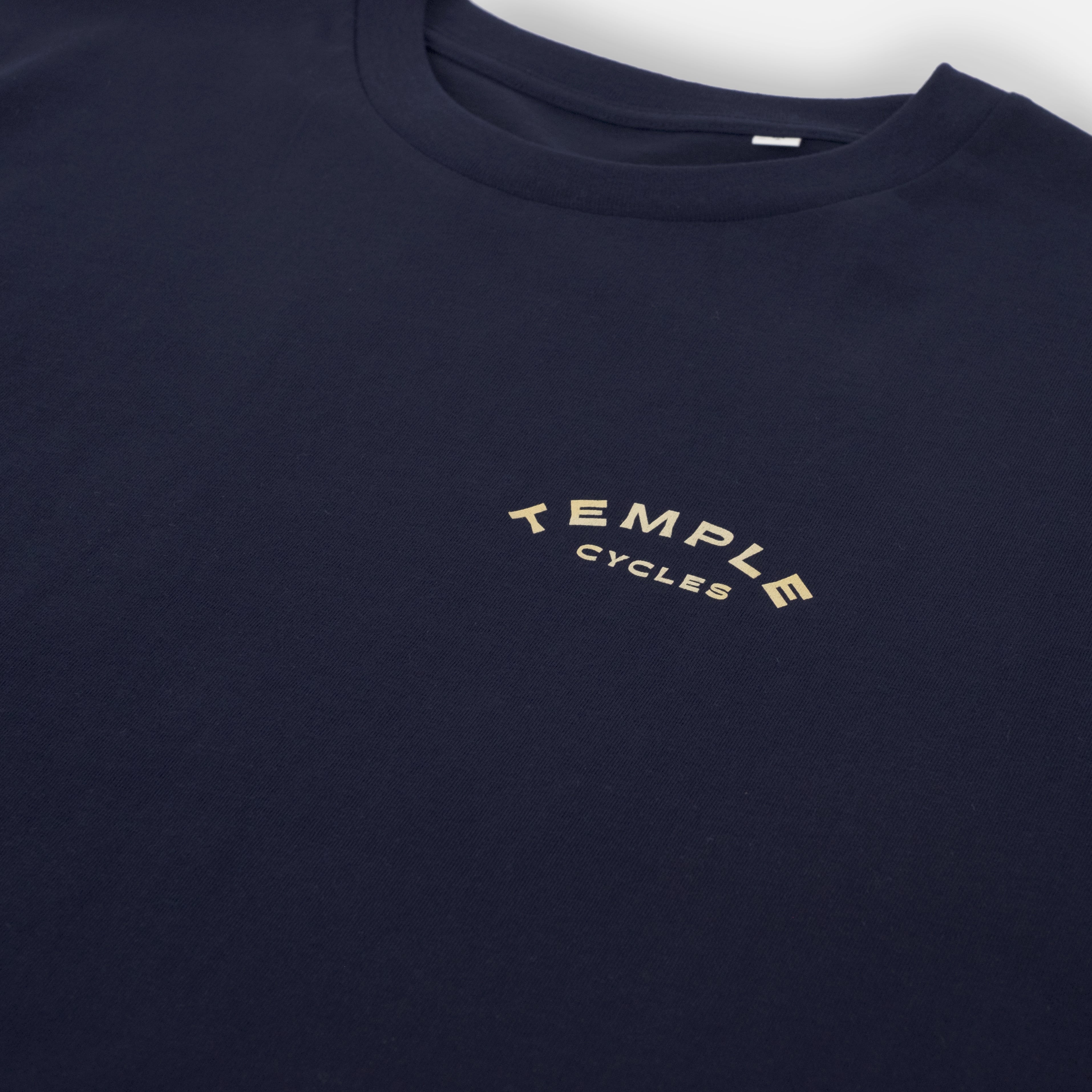 Temple Cycles logo on sustainable unisex graphic tee, studio setting.