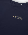 Temple Cycles logo on sustainable unisex graphic tee, studio setting.