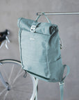 Teal waterproof bicycle Pannier backpack, urban setting.