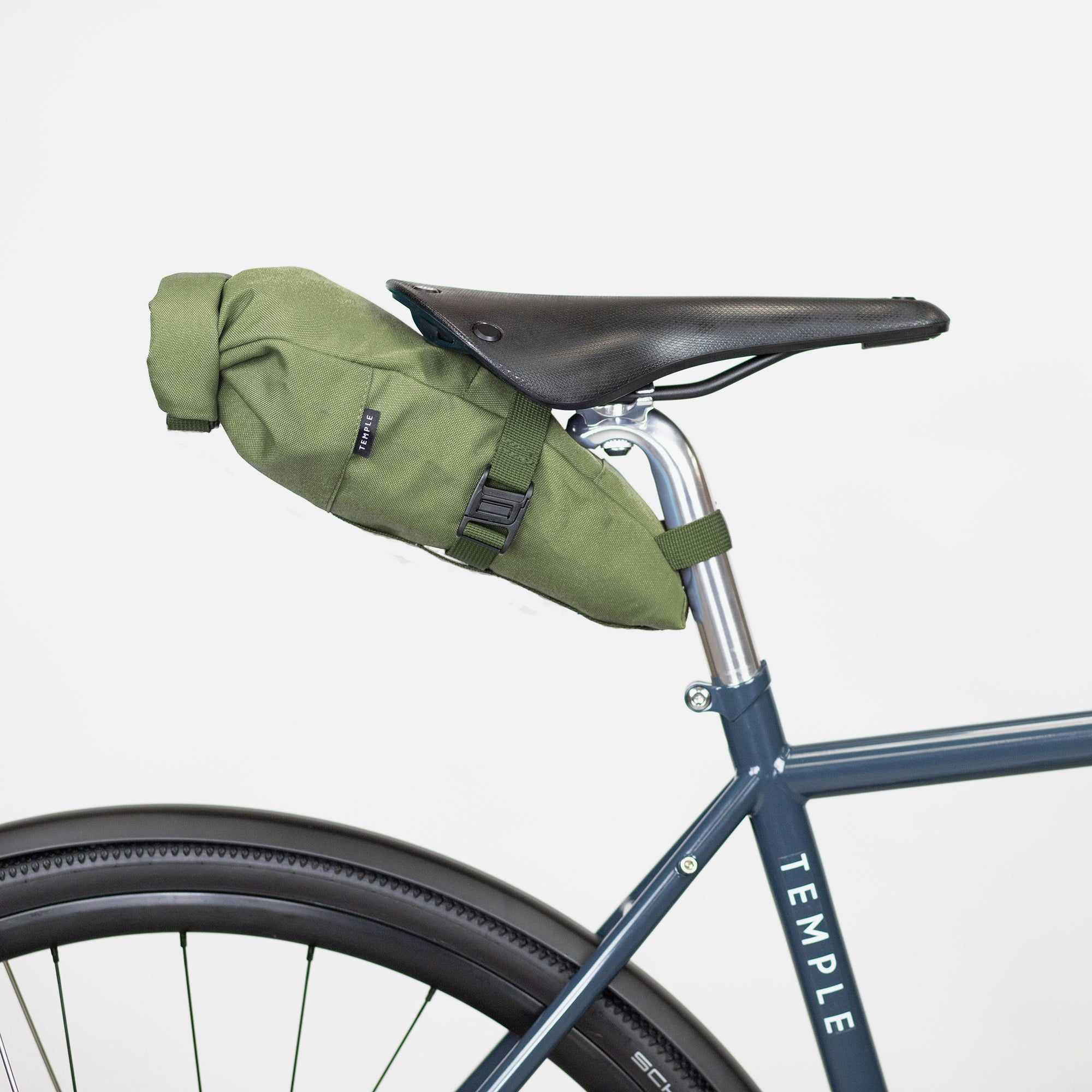 Waterproof, cycling saddle bag in green, studio setting. 