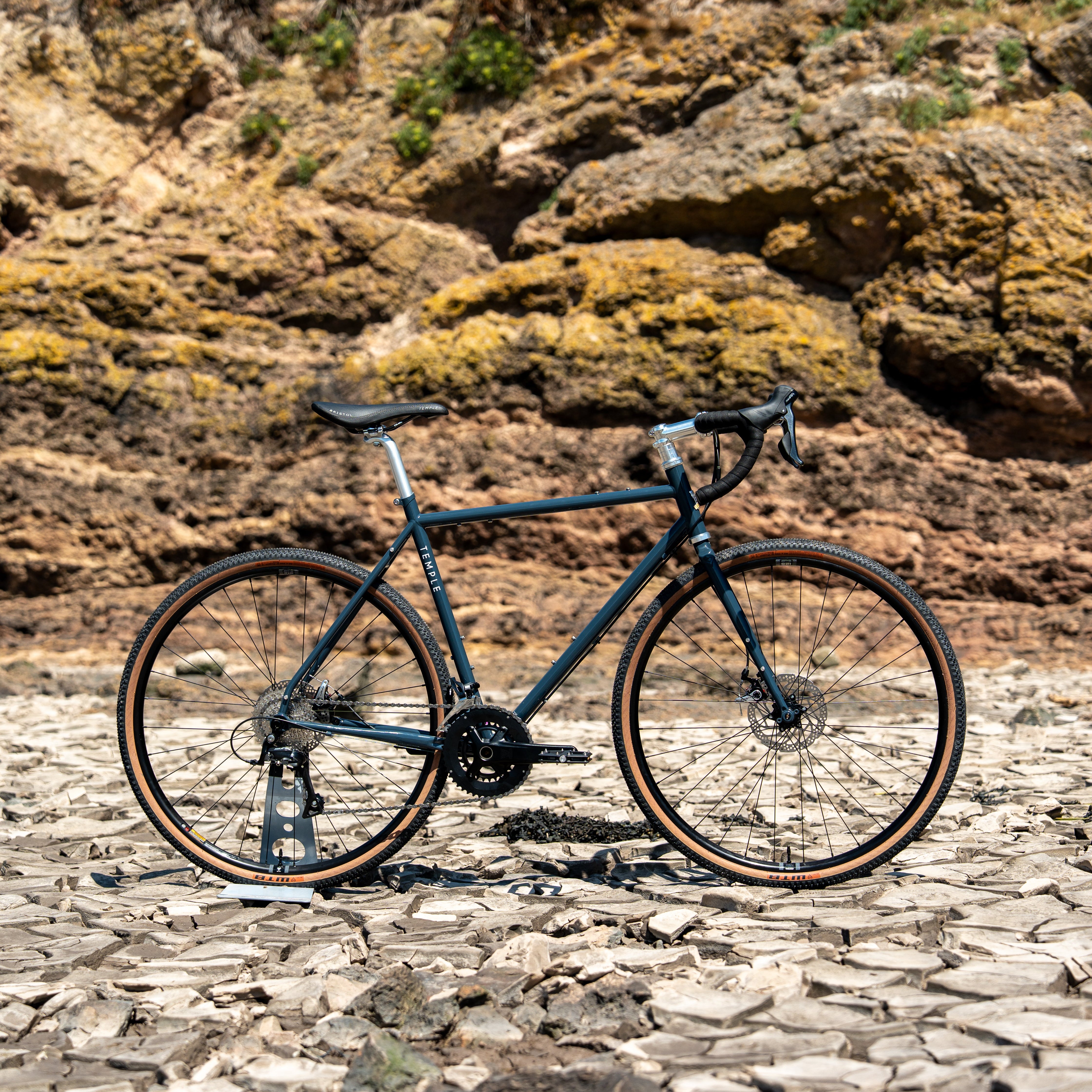 Bicycle on a rocky surface with a rocky cliff background