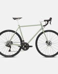 Green road bike with a steel lightweight frame, studio setting.