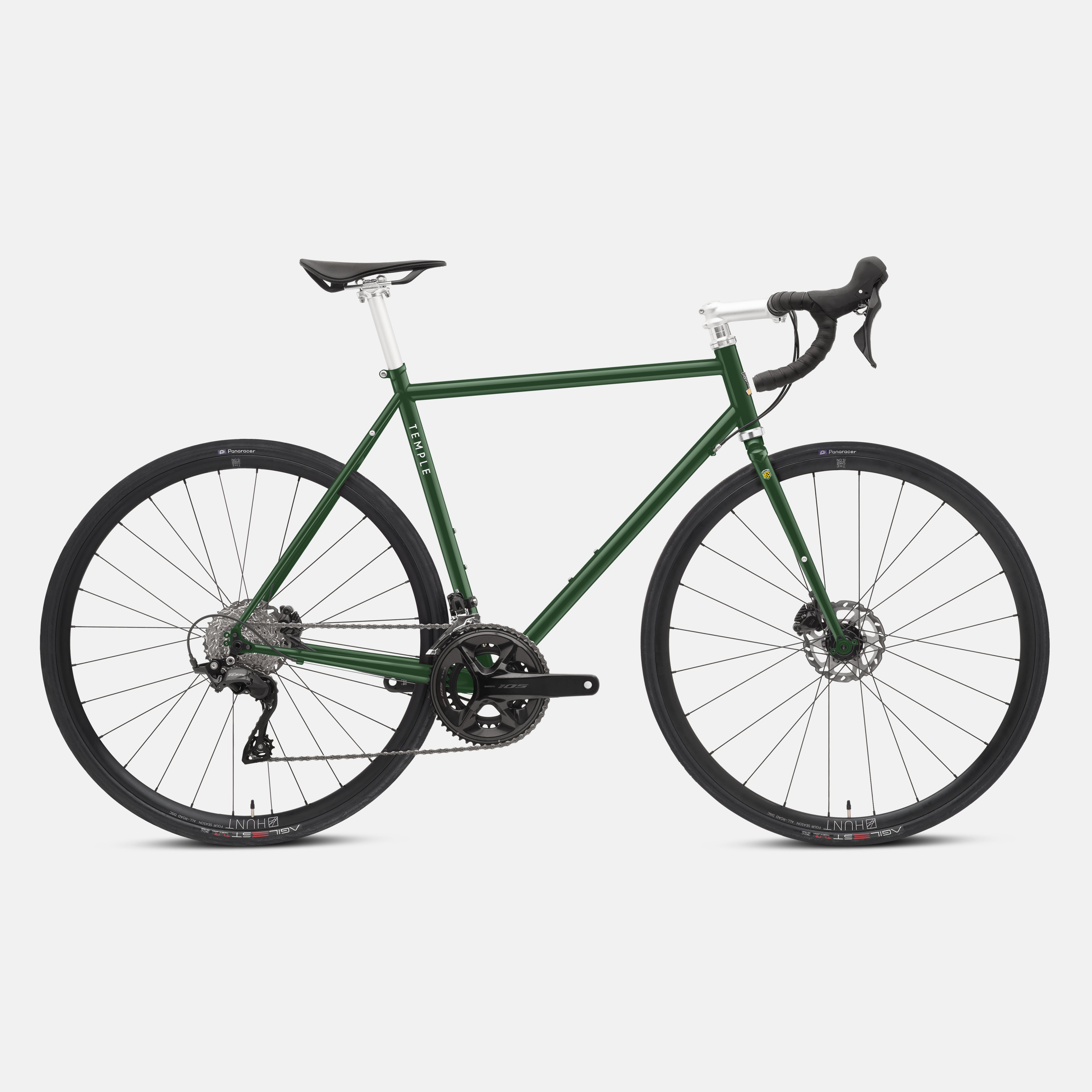 Dark green fast road bicycle, studio setting.