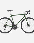 Dark green functional road bike with a lightweight steel frame, studio setting.