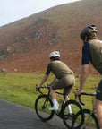 Three cyclists riding through mountainous scenery on lightweight, durable road bikes.
