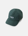 Temple corduroy cap made from 100% premium organic cotton in dark green, studio setting.