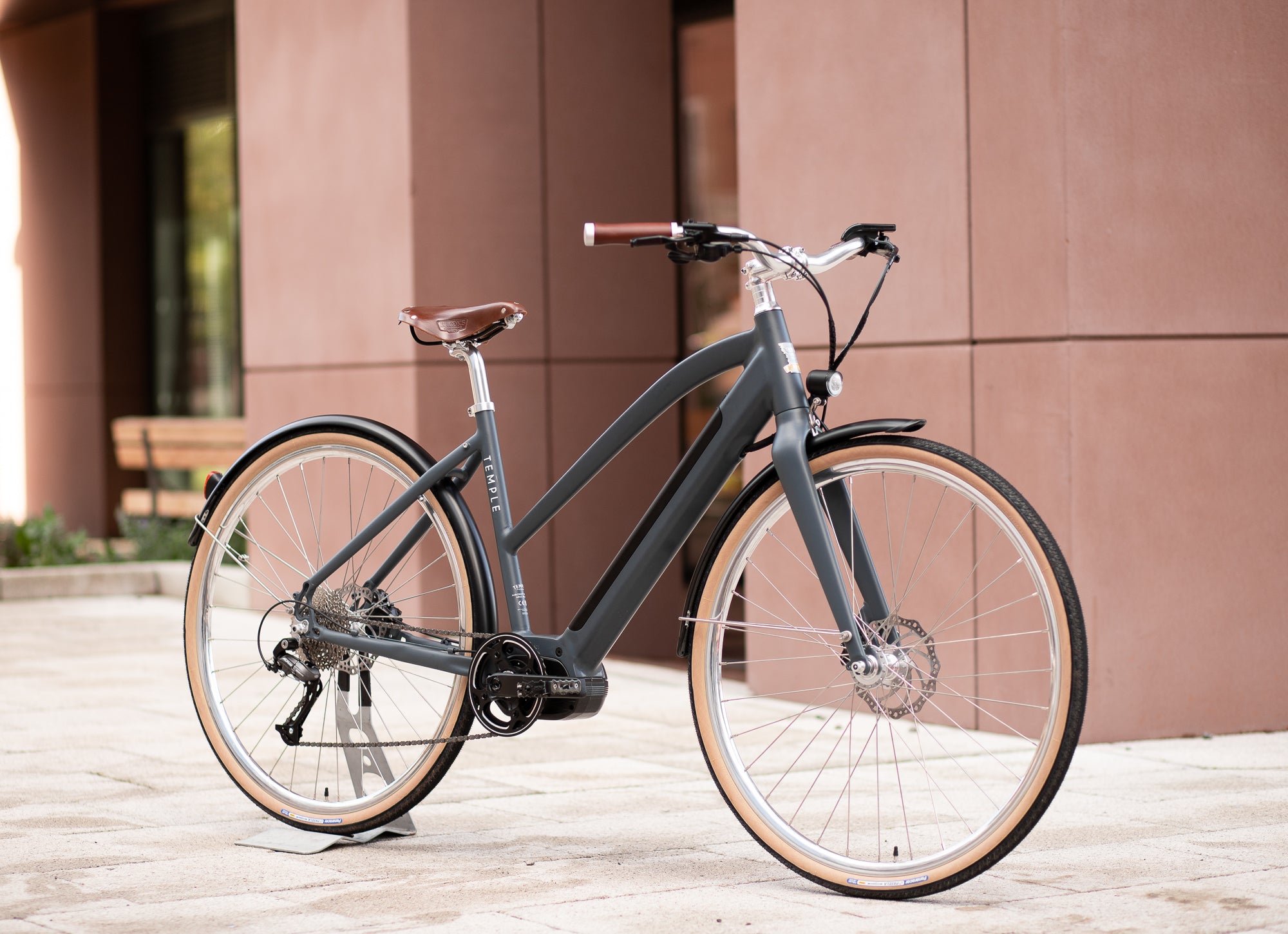 Gloss black Step Through women’s electric bike, urban setting. 