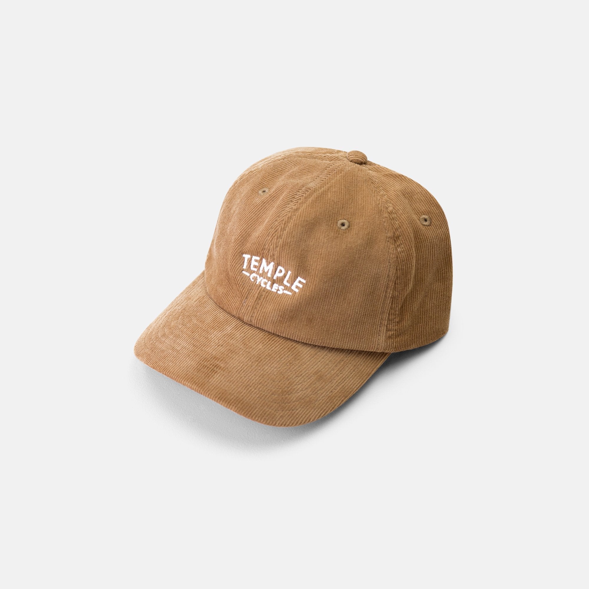 Brown corduroy cap made with 100% cotton, side view, studio setting.