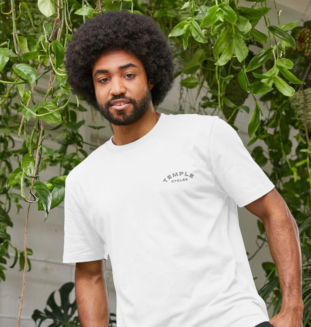 Subtle white graphic tee on a male model, urban setting. 