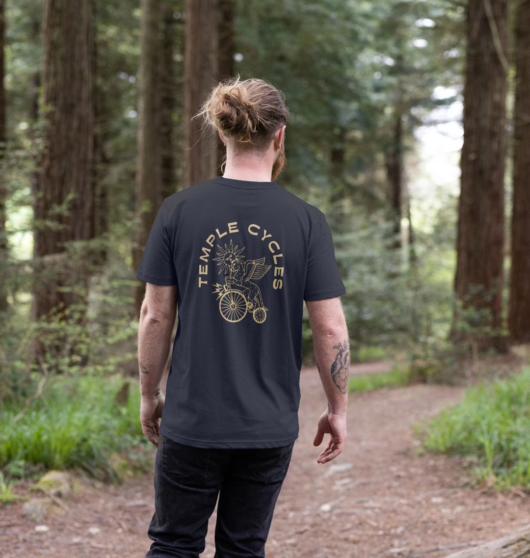 Men’s subtle style navy graphic T Shirt, back view, forest setting. 