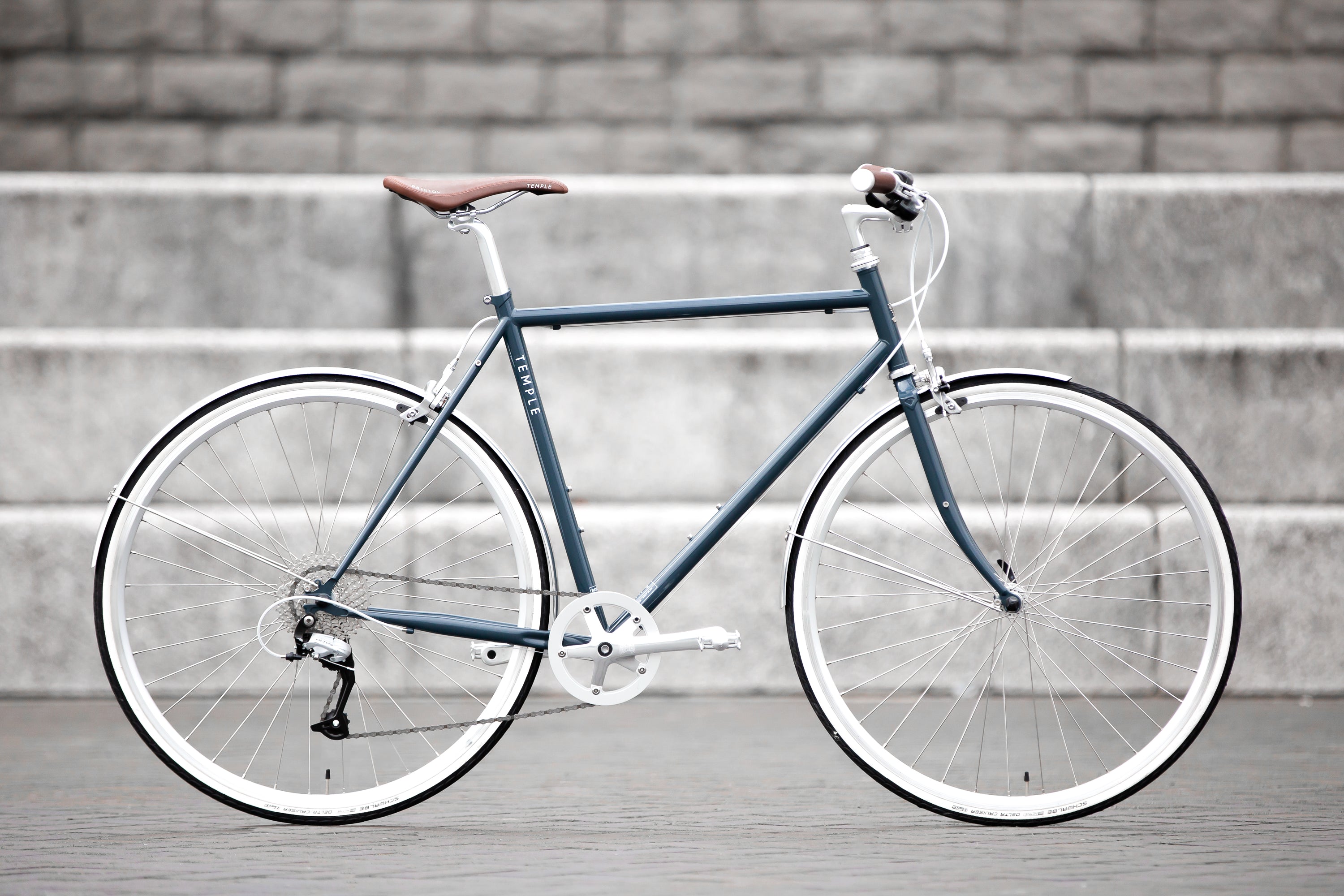 Classic lightweight blue commuting bike, urban setting.