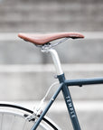 Temple Bristol leather saddle on a steel lightweight hybrid bike, urban setting.