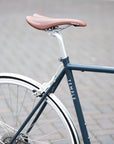 Rear wheel and leather saddle on a classic lightweight Temple steel, city bike.