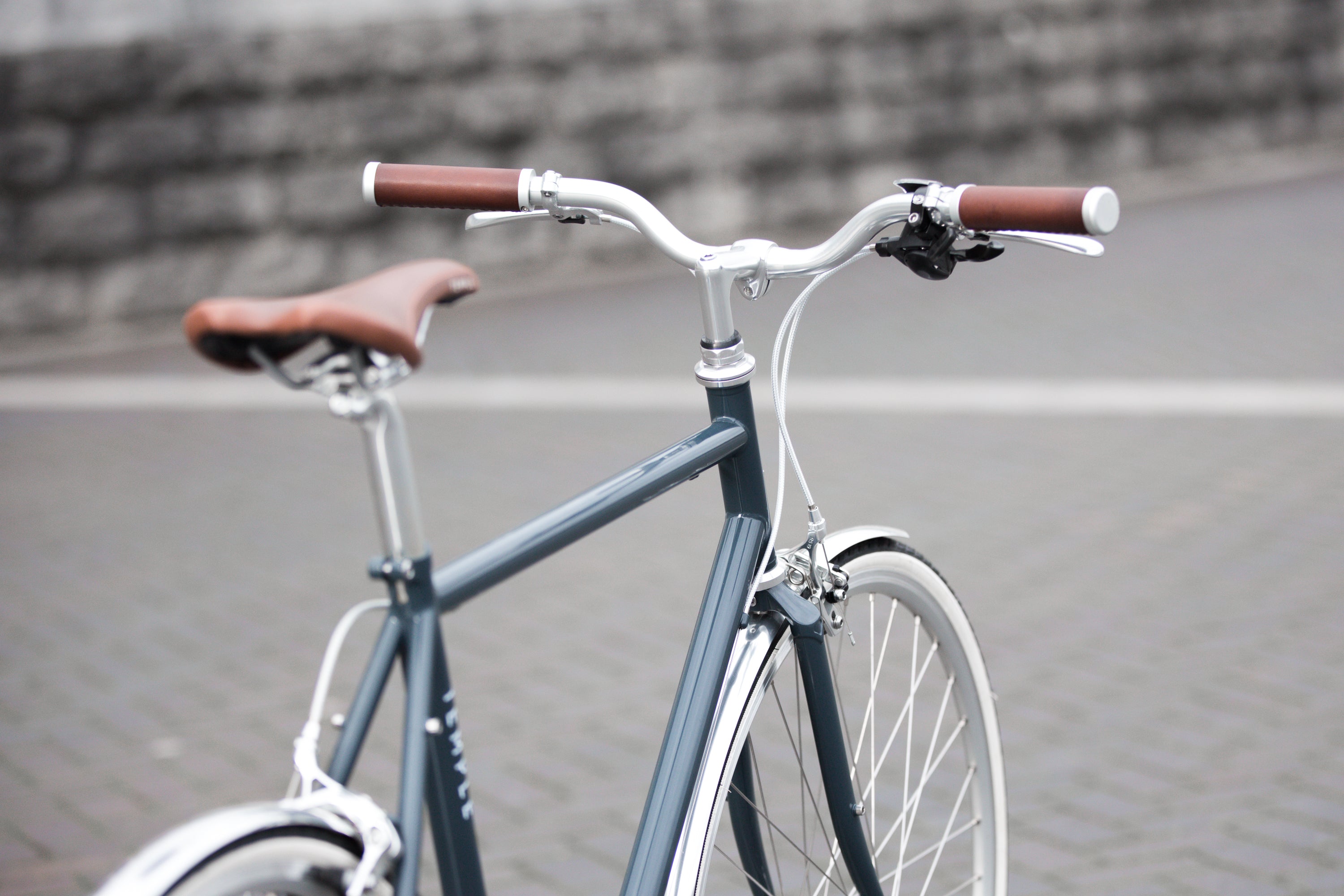 Rear view of a classic lightweight daily commuter bike in dark blue.