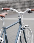 Rear view of a classic lightweight daily commuter bike in dark blue.