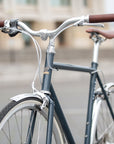 Front view of a classic lightweight steel bike in blue with Temple handlebars.