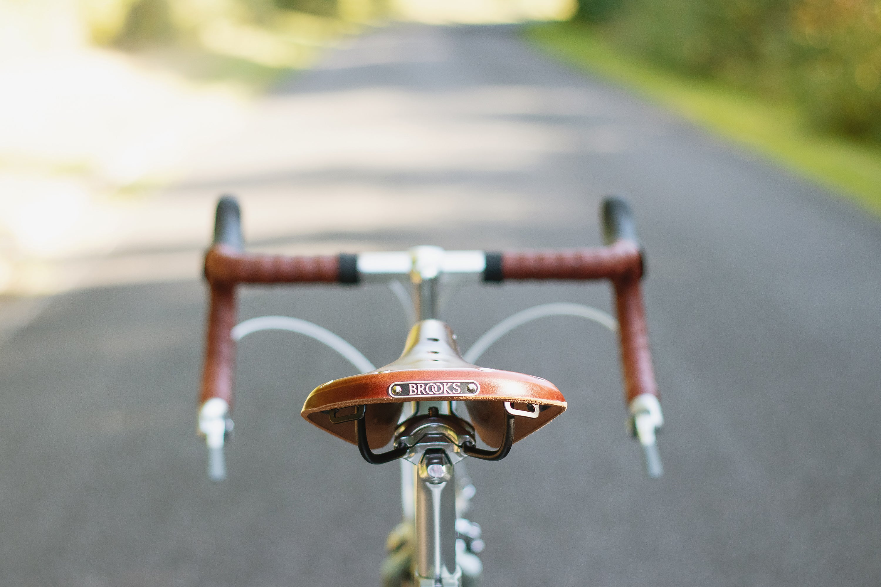 Brooks B17 leather saddle on a lightweight tourer  bike in a rural setting.