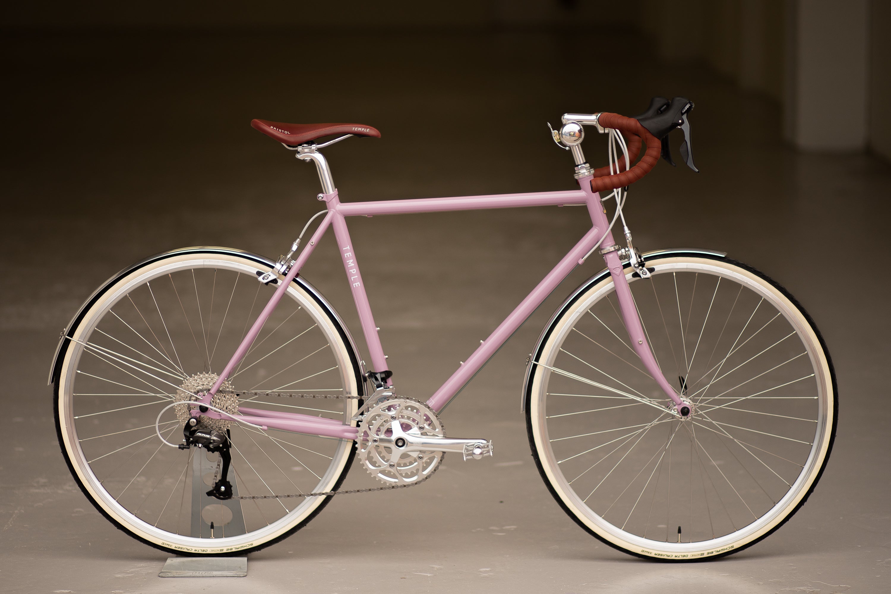 Pink steel tour  bike in an urban setting.