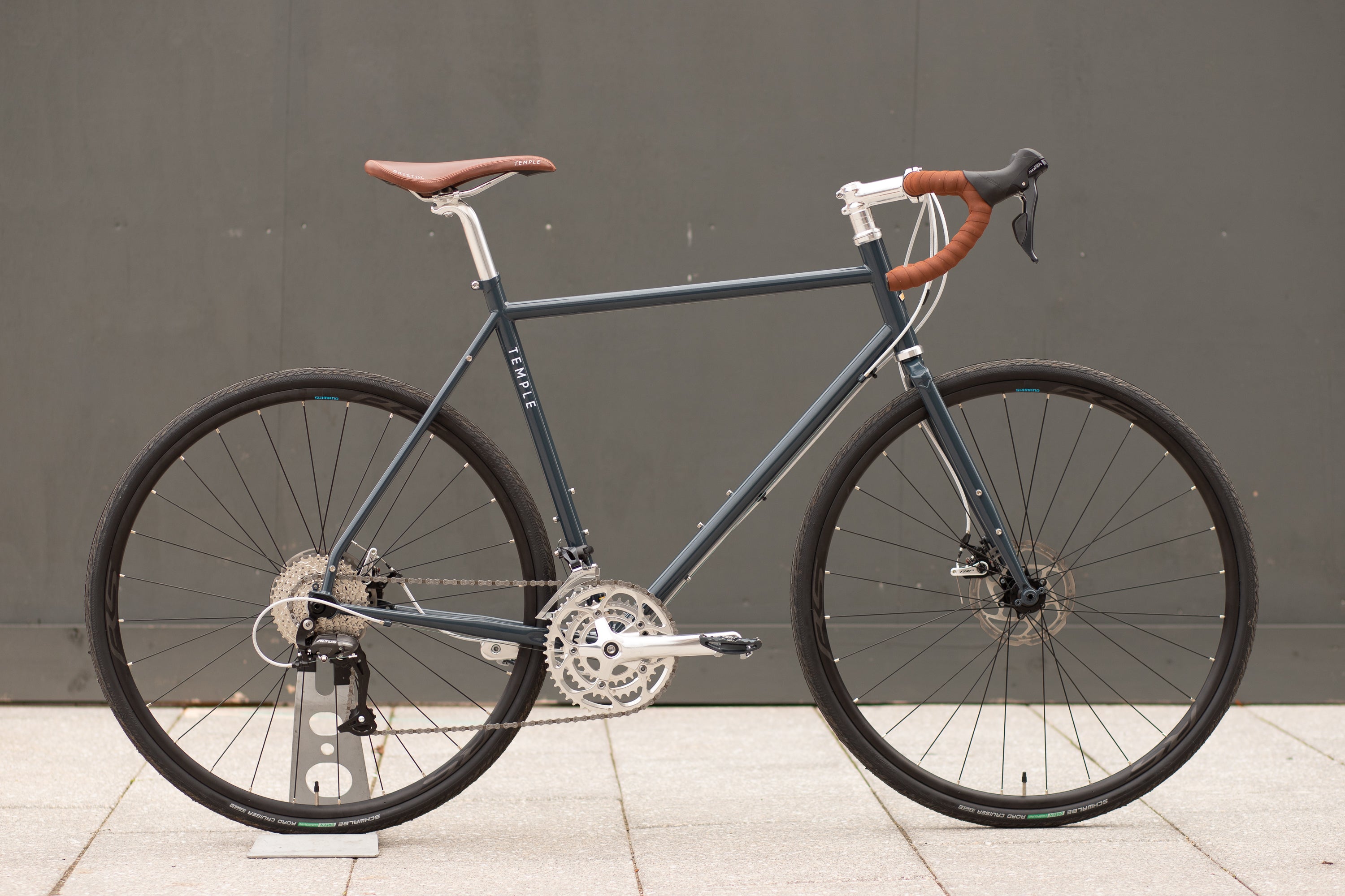 Lifestyle touring gravel bike in blue, urban setting.