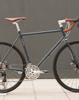 Lifestyle touring gravel bike in blue, urban setting.