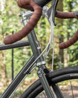 reynolds725, head tube and flared handlebars on a steel-framed adventure bike in racing-green.