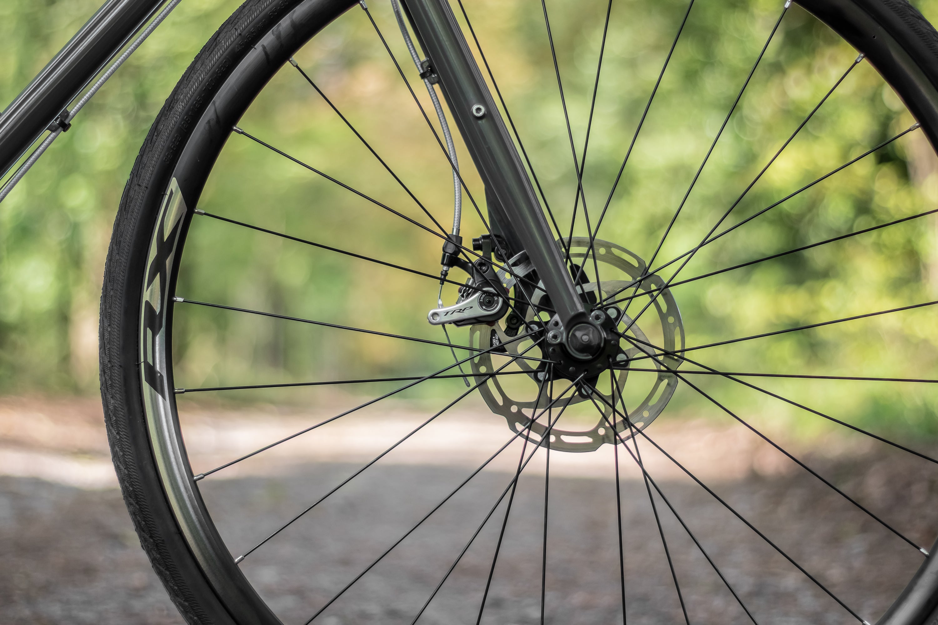 Front wheel handbuilt by Hunt with Shimano disc brakes on a lightweight touring bike.