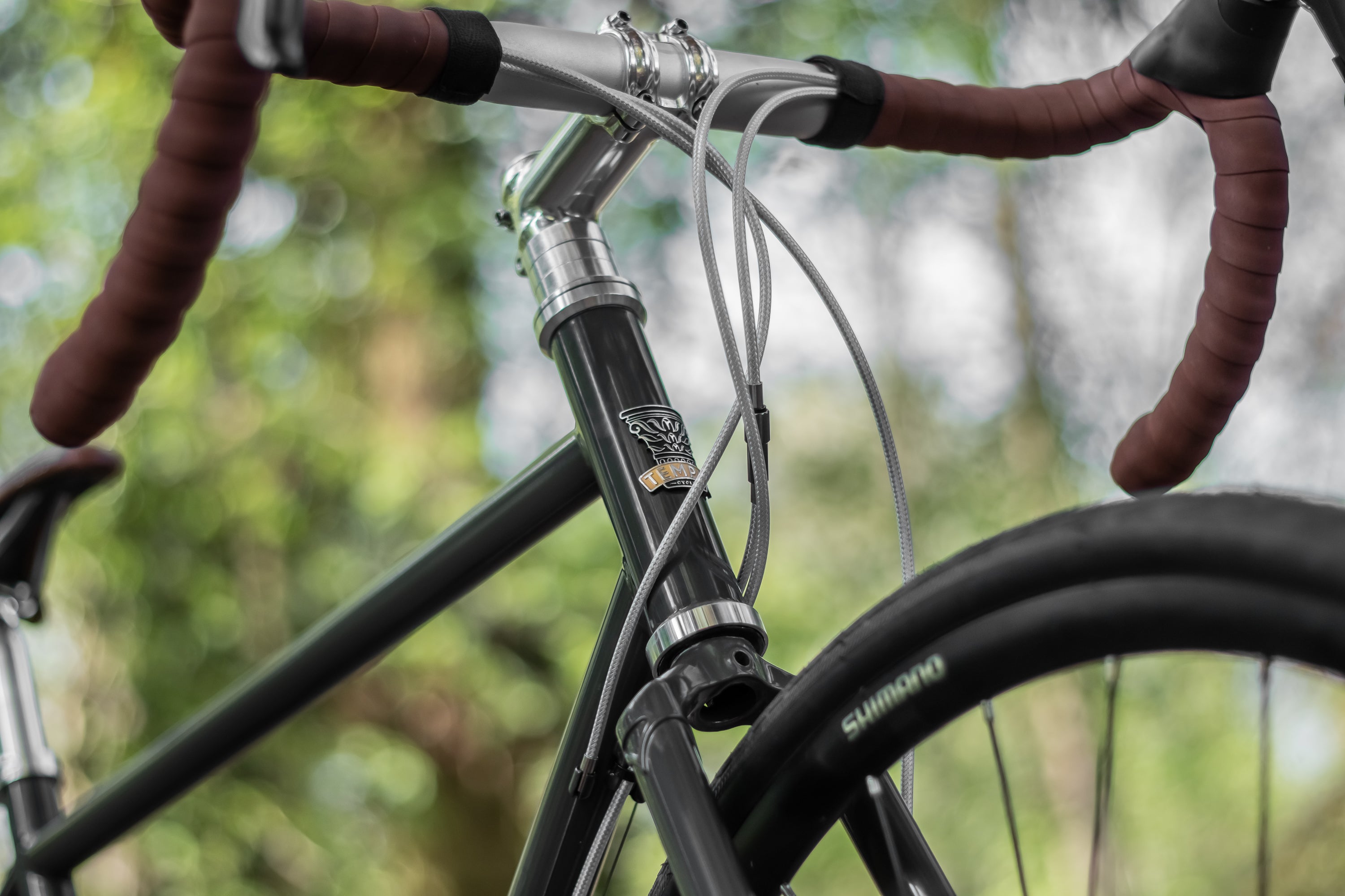 Racing green steel head tube and frame on a bikepacking gravel bike.