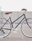 Timeless steel-framed commuting bike, urban setting.